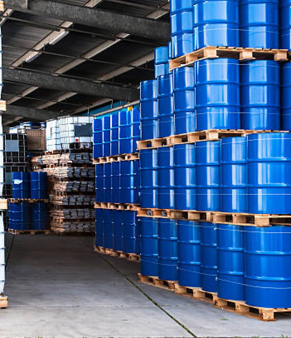 Blue drums and IBC container in a storage room